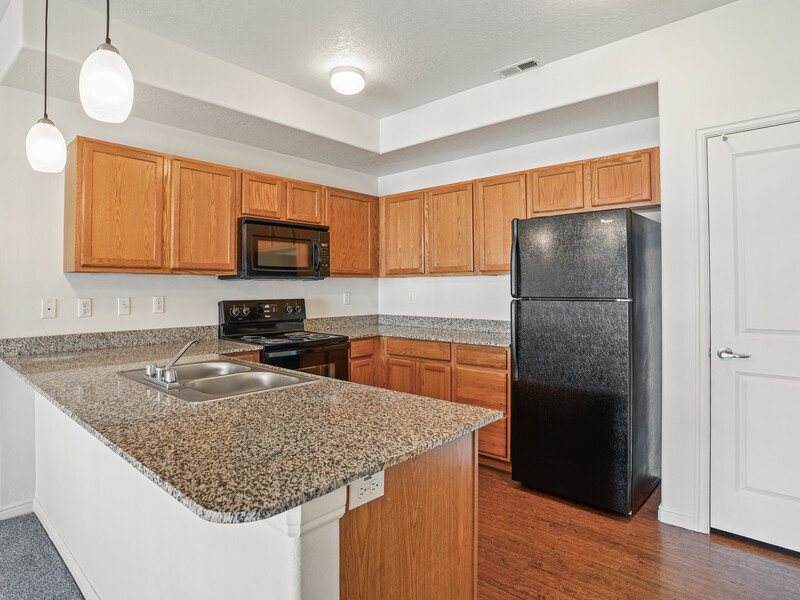 Classic Kitchen with Black Appliances | Viewpointe Apartments