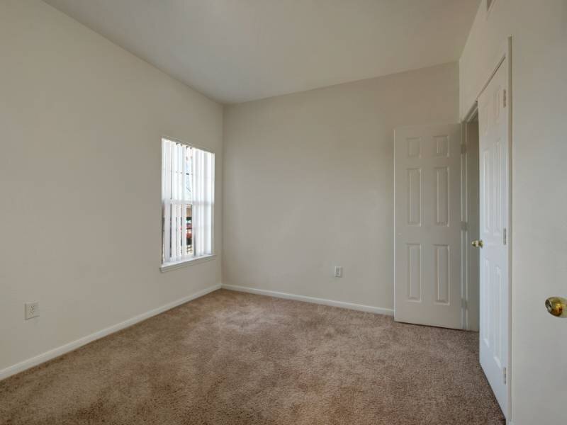 Carpeted Bedroom | Village Crest Apartments in Commerce City, CO