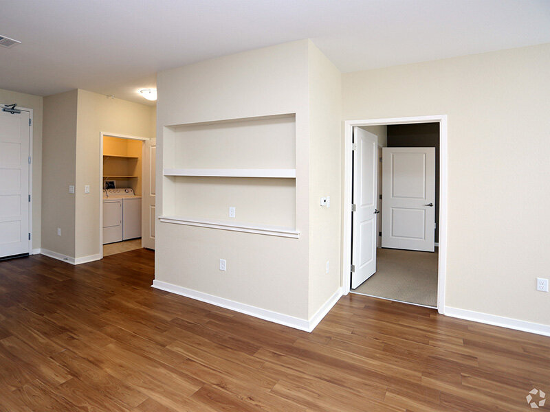Washer/Dryer with Wood Style Flooring and Shelves | Residence at University Hills