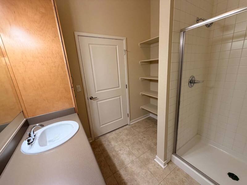 Bathroom with Linen Shelving | Residence at University Hills Apartments