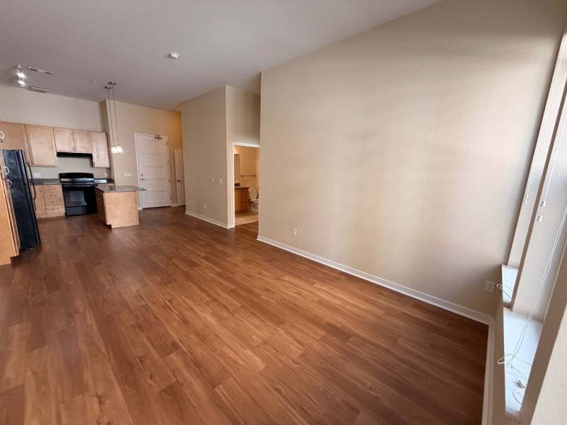 Living Room with Wood Like Flooring | Residence at University Hills Apartments