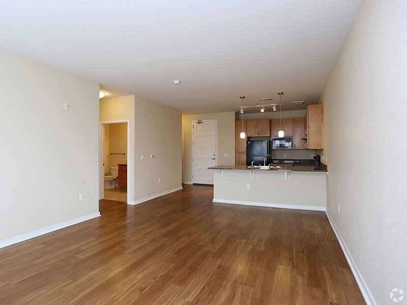 Kitchen with Wood Style Flooring and Bathroom Entrance | Residence at University Hills