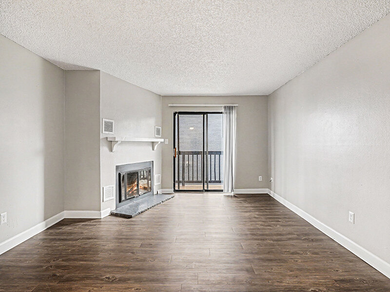 Fireplace in Living Room with Wood Styled Flooring and Patio Entrance | Innovation at Fitz