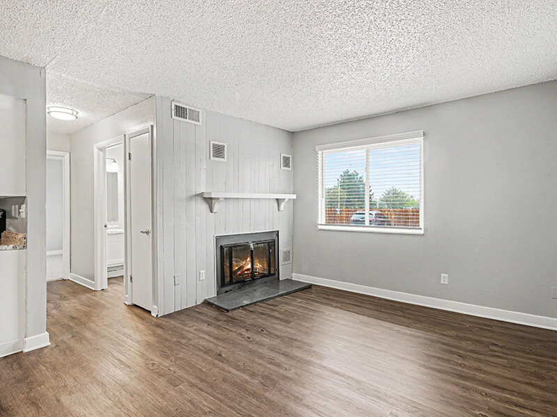 Living Room with Fireplace with Wood Styled Flooring | Innovation at Fitz