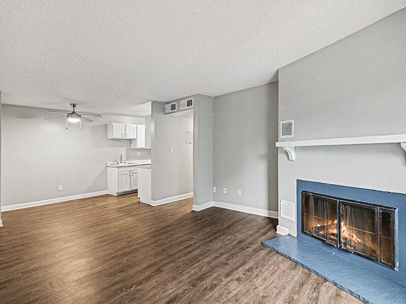 Living Room with Wood Styled Flooring and Large Fireplace | Innovation at Fitz