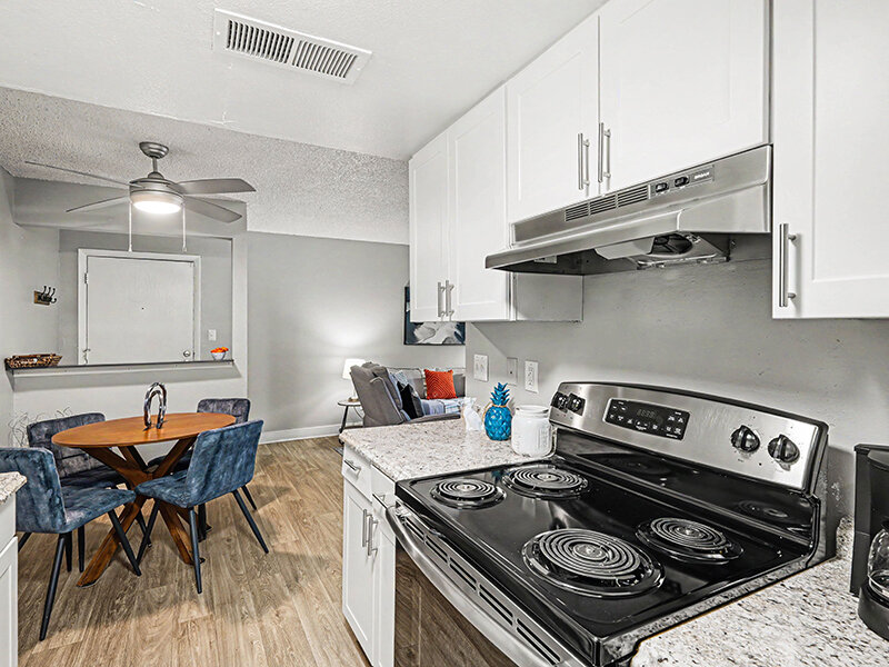 Kitchen Stove with Wood Styled Flooring and Ceiling Fan | Innovation at Fitz