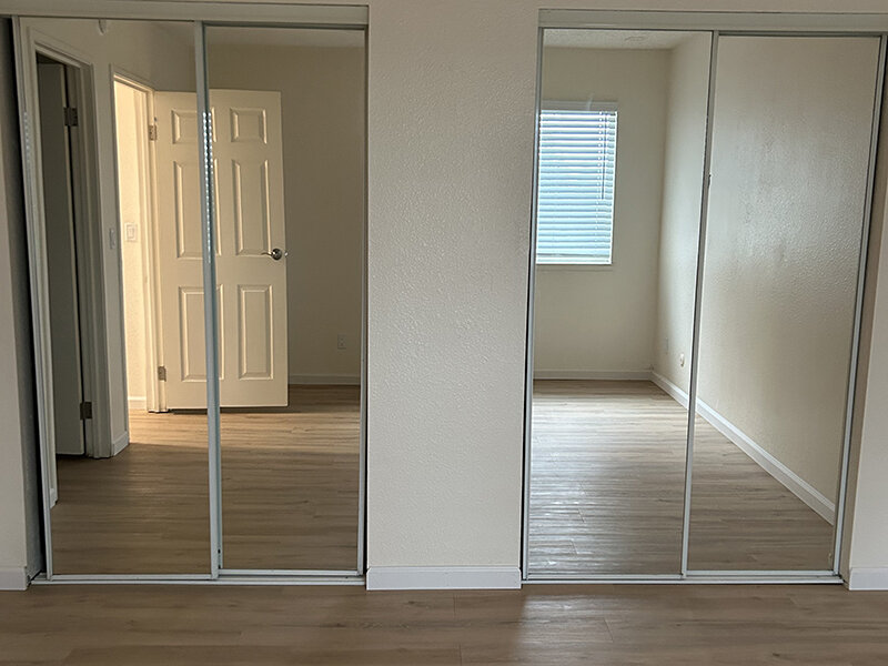 Bedroom Closets with Mirrors and Wood Style Flooring | Berryhill