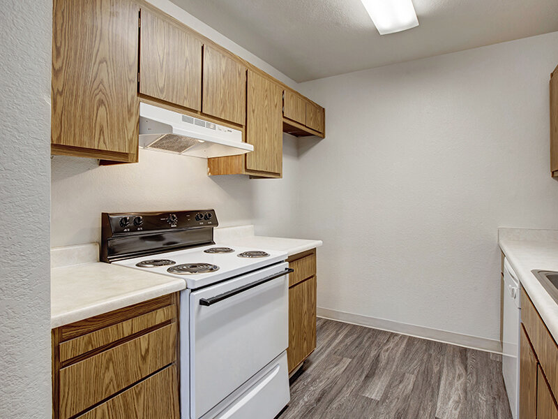Kitchen Stove with Cupboards and Wood Style Flooring | Arborelle Apartments