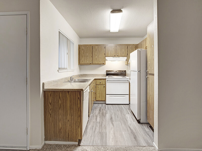 Kitchen Appliances with Window and Wood Style Flooring | Arborelle Apartments