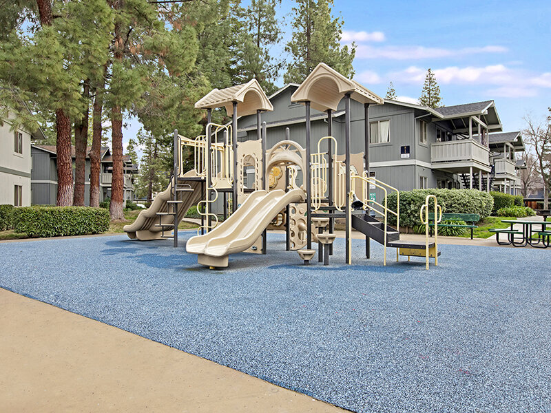 Outdoor Playground with Picnic Tables and Benches | Arborelle Apartments