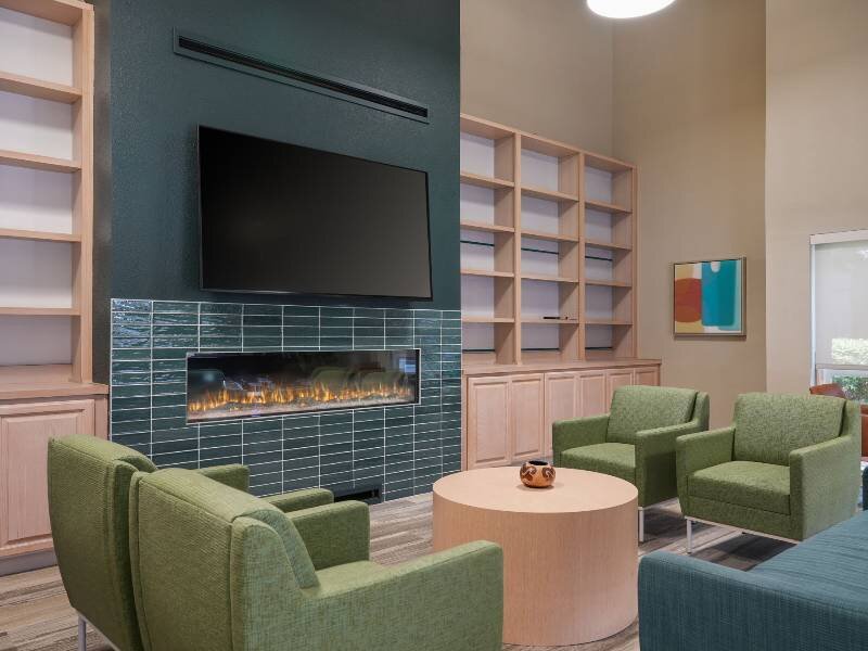 Clubhouse Lobby with Fireplace and Mounted TV | Albert Einstein Apartments