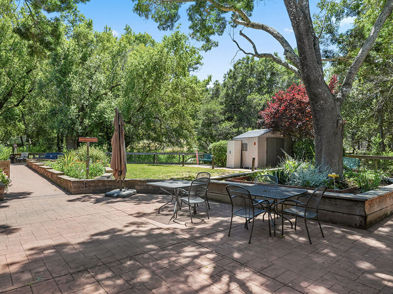 Monument Sign with Outdoor Seating and Patio Umbrella |  Parnow Friendship House