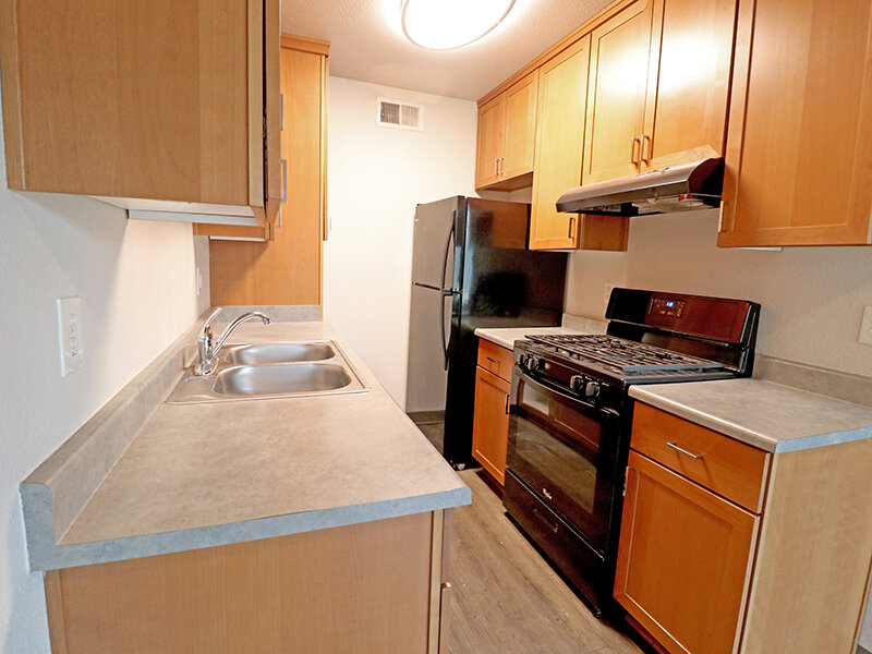 Kitchen Appliances with Wood Styled Cupboards | Broadway Apartments