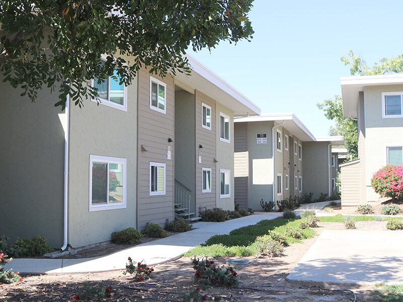 Apartment Property Exterior View with Walking Path | Broadway Apartments