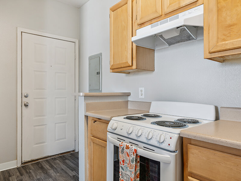 Kitchen Stove with Wooden Cupboards and Wood Style Flooring | Villa De San Felipe