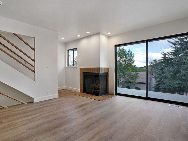 Living Room with Staircase and Fireplace | Residences at J Ranch