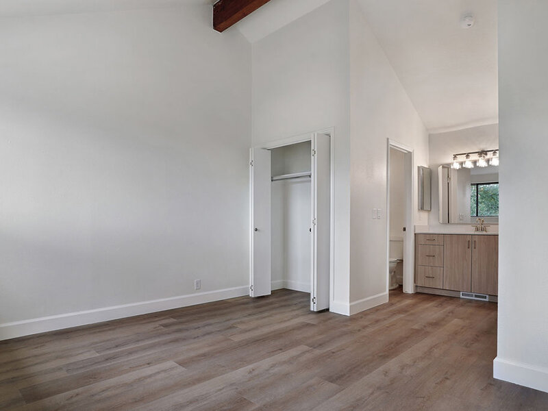 Bedroom with Open Closet and Wood Style Flooring and Lights | Residences at J Ranch
