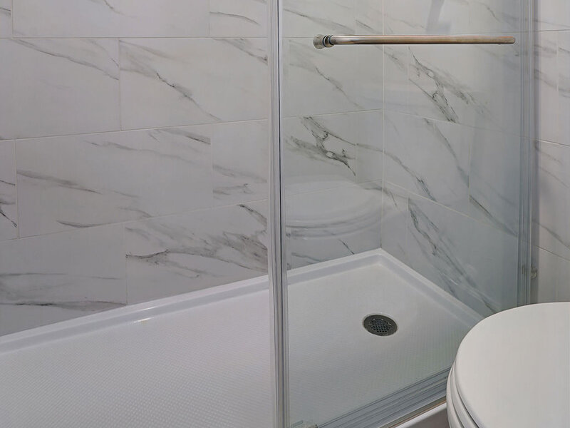 Bathroom with Shower with Marble Styled Walls | Residences at J Ranch