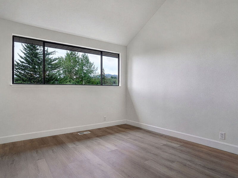 Bedroom with Window and Wood Style Flooring | Residences at J Ranch