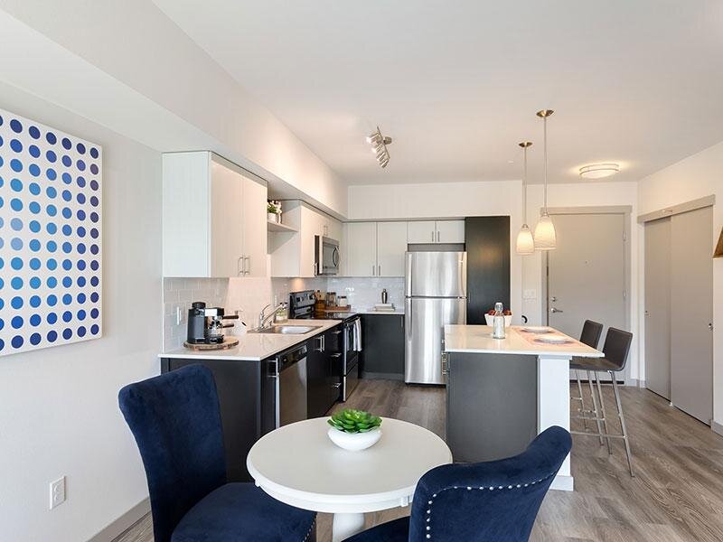 Kitchen with Dining Room Table and Kitchen Appliances | Tria