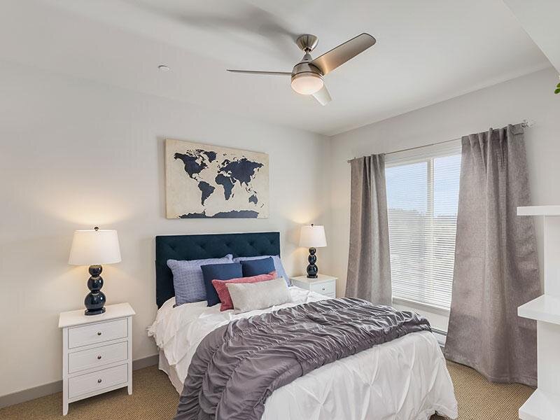 Bedroom with Window and Carpeted Flooring with Ceiling Fan | Tria
