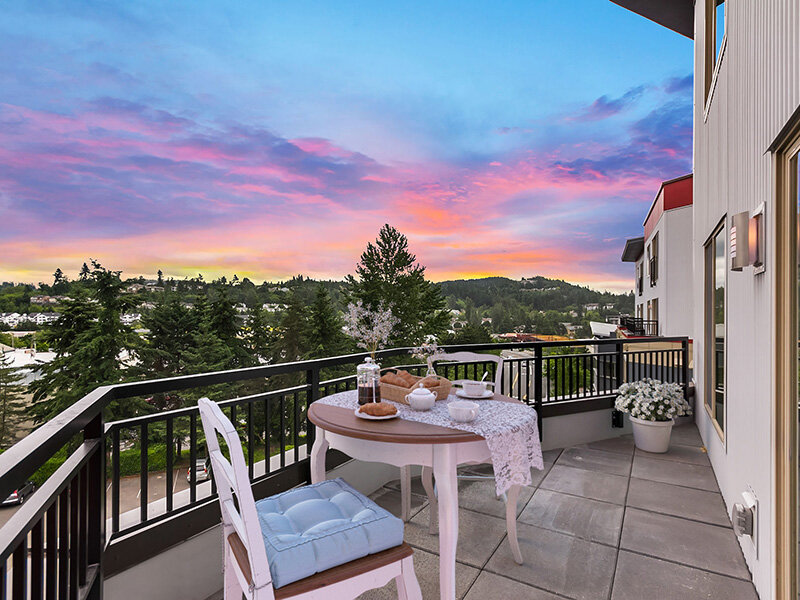 Patio Seating Outdoors with Tile Styled Flooring and Railing | Tria