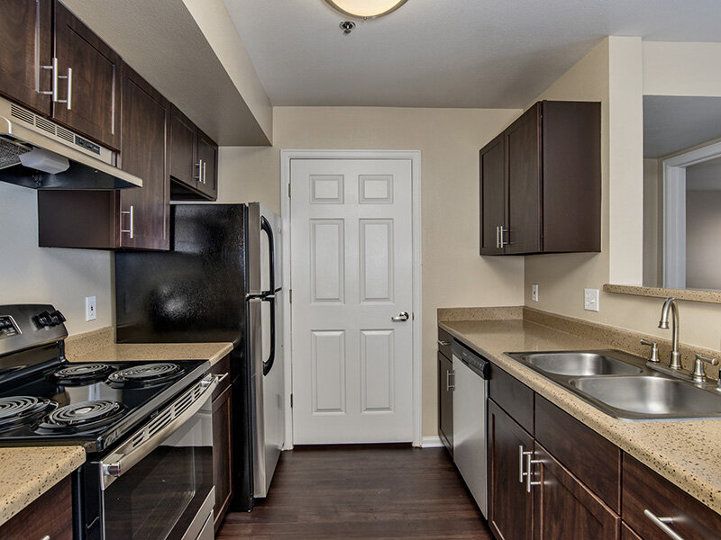 Kitchen with Refrigerator, and Wood Style Cupboards and Flooring | The Bluffs at Castle Rock