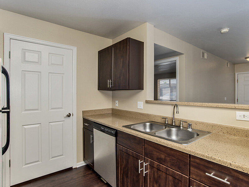 Kitchen Sink with Dishwasher and Wood Style Cupboards and Flooring | The Bluffs at Castle Rock