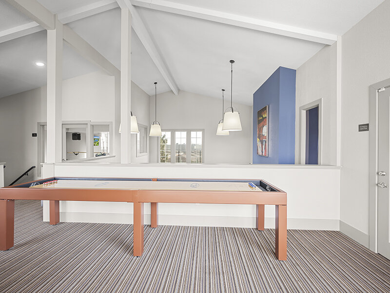Air Hockey Table on Carpeted Flooring with Hanging Ceiling Lights | Rosemont West 84th