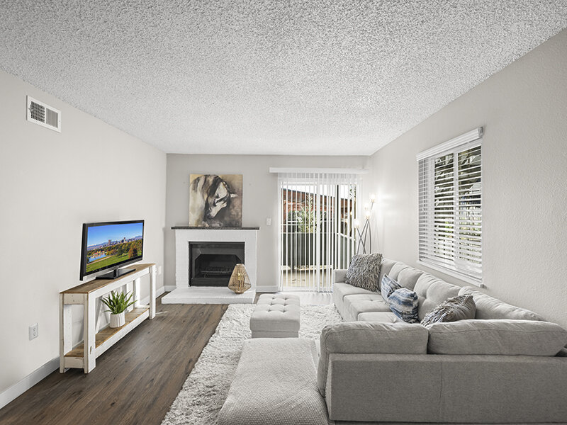 Living Room with Wood Styled Flooring, and Couch Sectional with Fireplace | Rosemont West 84th