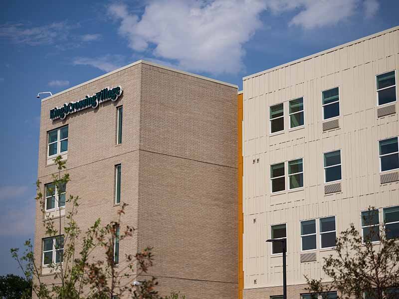 Apartment Exterior with Signage | King's Crossing Village