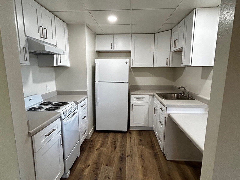 Apartment Kitchen with Wood Style Flooring and Cabinets | Riverside