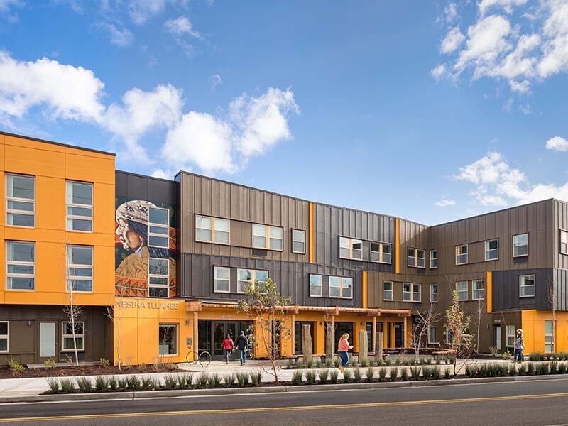 Exterior Apartment Complex with Nearby Highway | Nesika Illahee