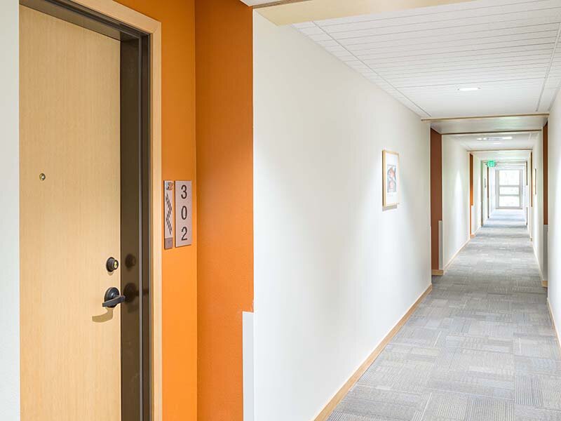 Apartment Complex Hallway with Apartment Door | Nesika Illahee