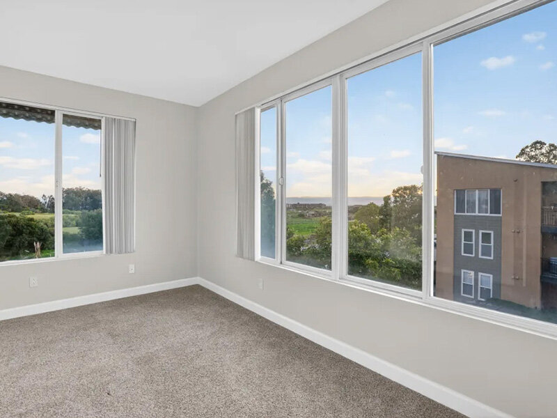 Living Room with Open Windows and Carpeted Flooring | Pacific Shores