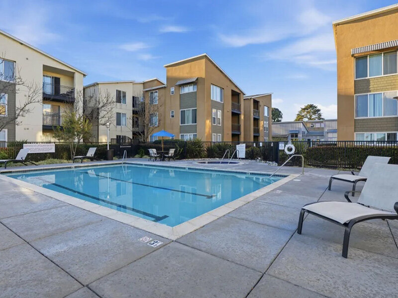 Apartment Pool with Lounge Chair Seating | Pacific Shores