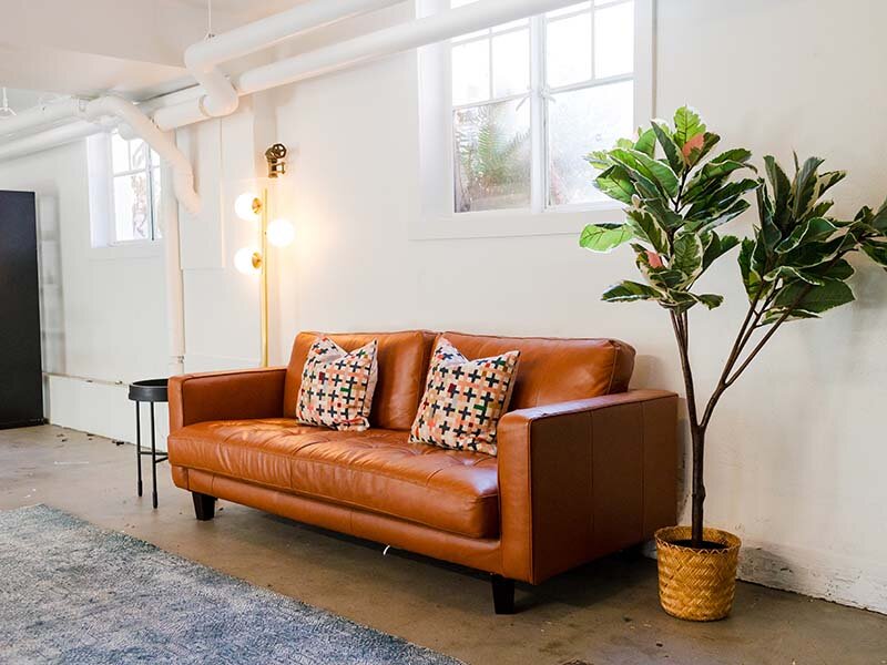 Community Sofa with Wood Styled Flooring and Rug | Milepost 5