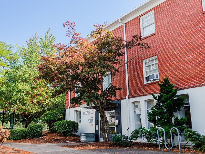 Apartment Entrance with Sidewalk and Foliage | Milepost 5