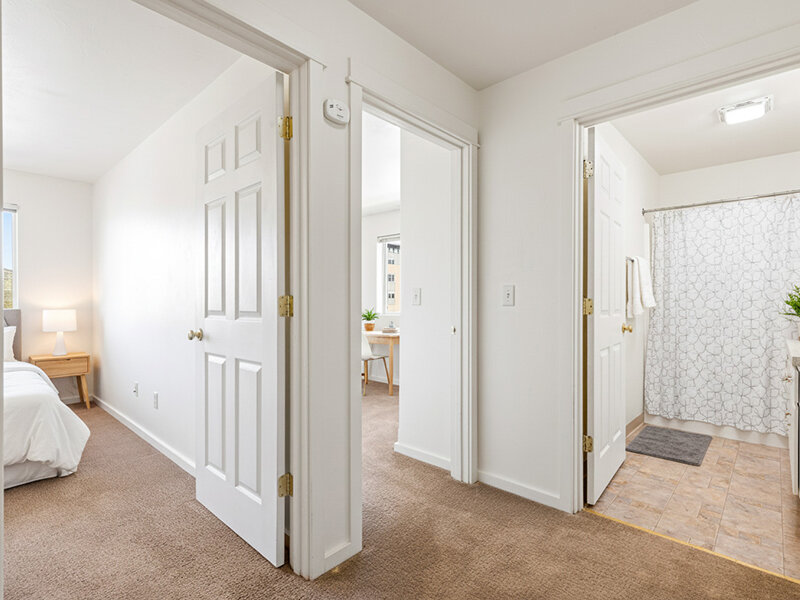 Interior Hallway with Carpeted Flooring and Open Doors | Kagy Village
