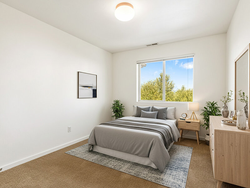 Bedroom with Window and Carpeted Flooring with Wall Art | Kagy Village