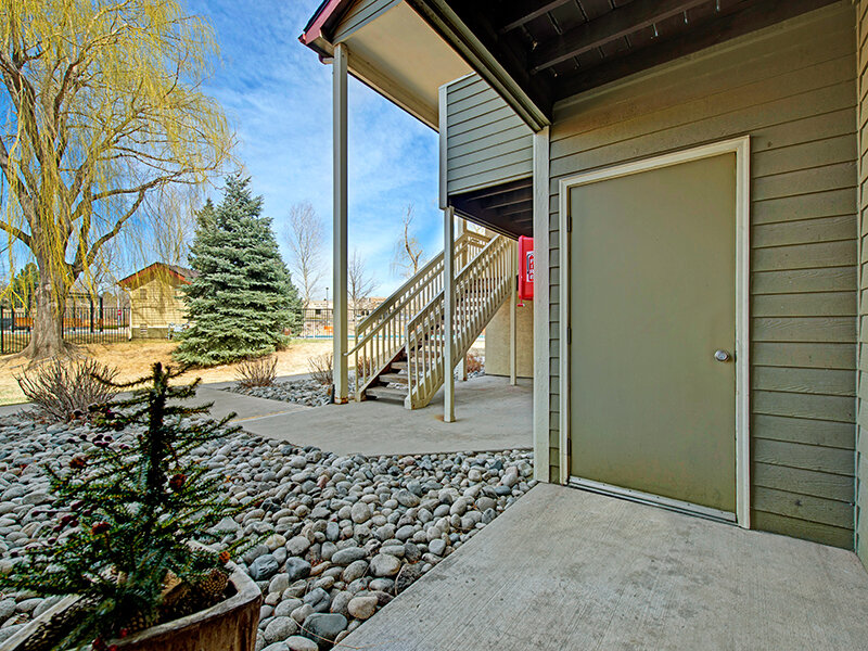 Exterior Apartment Entrance with Rock Flooring | The Willows at Printers Park Apartments