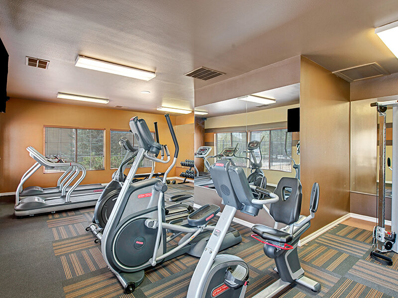 Community Room with Exercise Equipment | The Willows at Printers Park Apartments