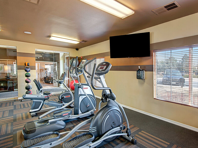 Community Fitness Room with Exercise Equipment and Television | The Willows at Printers Park Apartments
