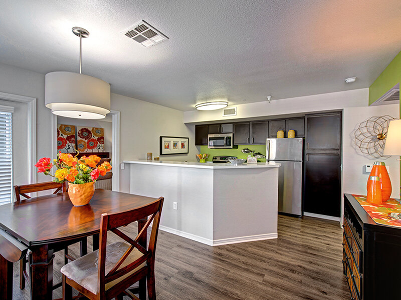 Dining Table with Ceiling Light and Kitchen Entrance with Wood Styled Flooring | The Willows at Printers Park Apartments