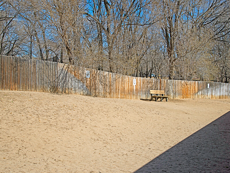 Exterior View with Outdoor Bench and Trees | The Willows at Printers Park Apartments