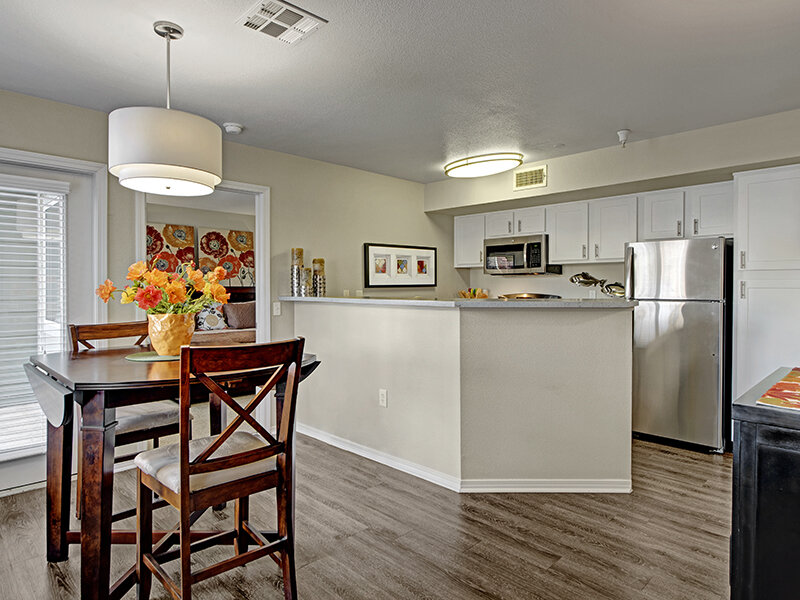 Kitchen with Dining Room Table on Wood Styled Flooring | The Willows at Printers Park Apartments