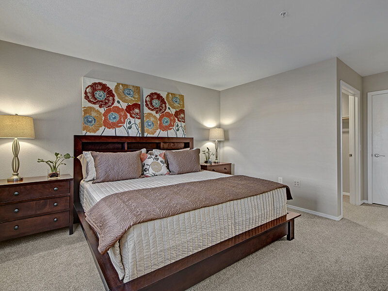 Apartment Bedroom with Carpeted Flooring and Nightstand | The Willows at Printers Park Apartments