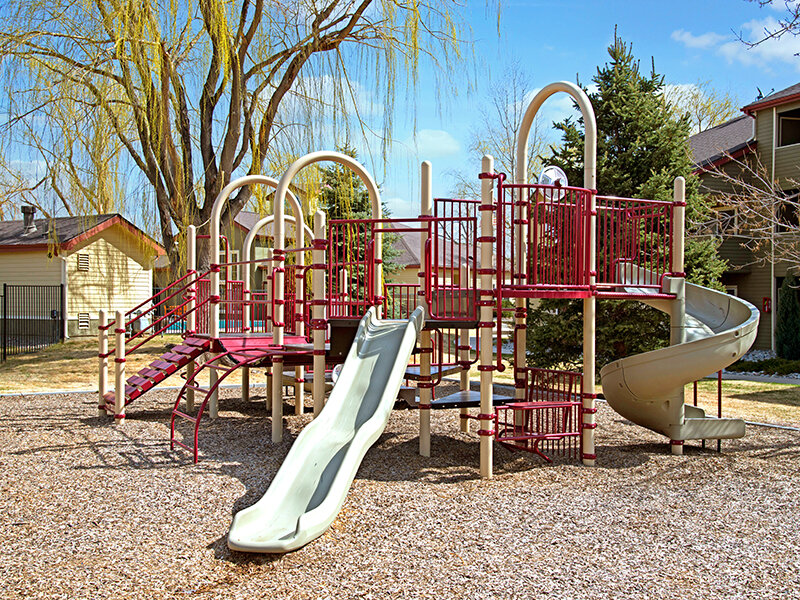 Exterior Community Playground with Slide | The Willows at Printers Park Apartments