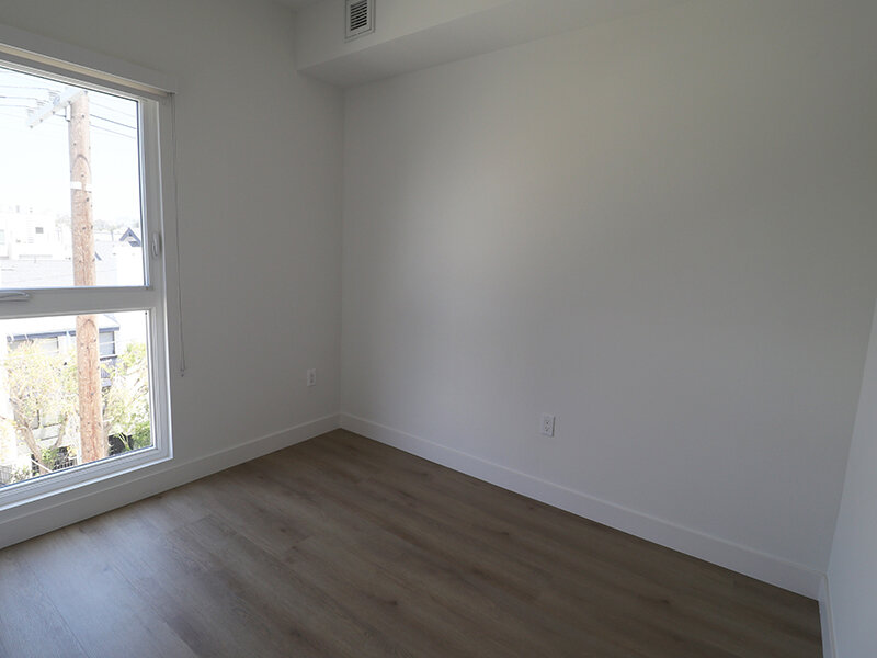 Bedroom with Large Windows and Wood Floors | Missouri Apartments