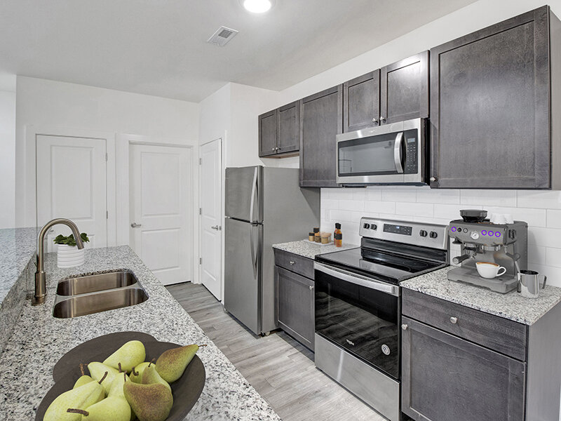 Kitchen with Wood Style Cabinets and Counter | Merchants Walk
